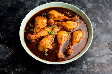 Chicken leg / drumstick curry or Murg Tangri/tangdi masala. Served in a bowl over moody background. Selective focus