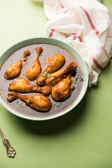 Chicken leg / drumstick curry or Murg Tangri/tangdi masala. Served in a bowl over moody background. Selective focus