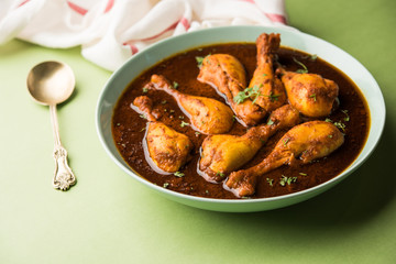 Chicken leg / drumstick curry or Murg Tangri/tangdi masala. Served in a bowl over moody background. Selective focus