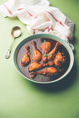 Chicken leg / drumstick curry or Murg Tangri/tangdi masala. Served in a bowl over moody background. Selective focus