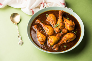 Chicken leg / drumstick curry or Murg Tangri/tangdi masala. Served in a bowl over moody background. Selective focus