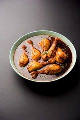 Chicken leg / drumstick curry or Murg Tangri/tangdi masala. Served in a bowl over moody background. Selective focus