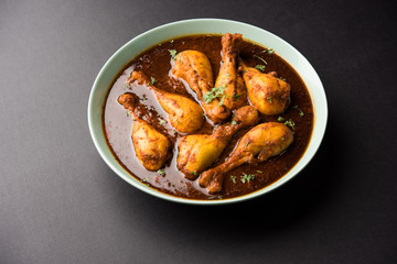 Chicken leg / drumstick curry or Murg Tangri/tangdi masala. Served in a bowl over moody background. Selective focus