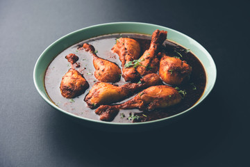 Chicken leg / drumstick curry or Murg Tangri/tangdi masala. Served in a bowl over moody background. Selective focus