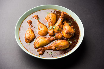 Chicken leg / drumstick curry or Murg Tangri/tangdi masala. Served in a bowl over moody background. Selective focus