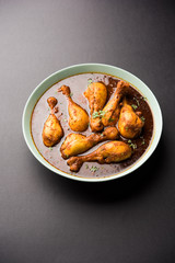 Chicken leg / drumstick curry or Murg Tangri/tangdi masala. Served in a bowl over moody background. Selective focus