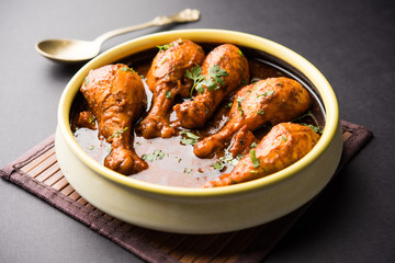 Chicken leg / drumstick curry or Murg Tangri/tangdi masala. Served in a bowl over moody background. Selective focus
