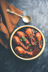 Chicken leg / drumstick curry or Murg Tangri/tangdi masala. Served in a bowl over moody background. Selective focus
