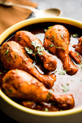 Chicken leg / drumstick curry or Murg Tangri/tangdi masala. Served in a bowl over moody background. Selective focus