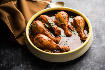 Chicken leg / drumstick curry or Murg Tangri/tangdi masala. Served in a bowl over moody background. Selective focus