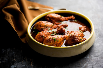 Chicken leg / drumstick curry or Murg Tangri/tangdi masala. Served in a bowl over moody background. Selective focus