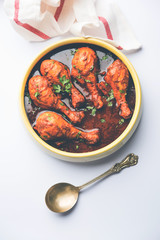 Chicken leg / drumstick curry or Murg Tangri/tangdi masala. Served in a bowl over moody background. Selective focus