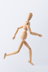 running wooden mannequin isolated on white background