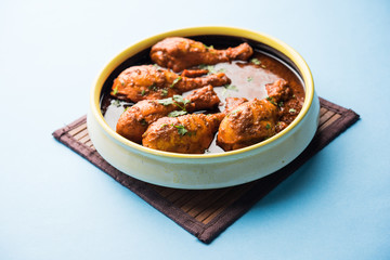Chicken leg / drumstick curry or Murg Tangri/tangdi masala. Served in a bowl over moody background. Selective focus