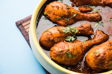 Chicken leg / drumstick curry or Murg Tangri/tangdi masala. Served in a bowl over moody background. Selective focus