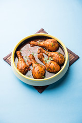 Chicken leg / drumstick curry or Murg Tangri/tangdi masala. Served in a bowl over moody background. Selective focus