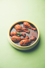 Chicken leg / drumstick curry or Murg Tangri/tangdi masala. Served in a bowl over moody background. Selective focus