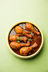 Chicken leg / drumstick curry or Murg Tangri/tangdi masala. Served in a bowl over moody background. Selective focus