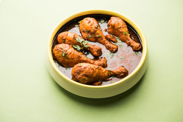 Chicken leg / drumstick curry or Murg Tangri/tangdi masala. Served in a bowl over moody background. Selective focus