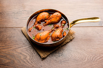 Chicken leg / drumstick curry or Murg Tangri/tangdi masala. Served in a bowl over moody background. Selective focus