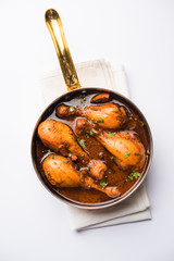 Chicken leg / drumstick curry or Murg Tangri/tangdi masala. Served in a bowl over moody background. Selective focus