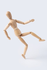 falling wooden mannequin isolated on white background