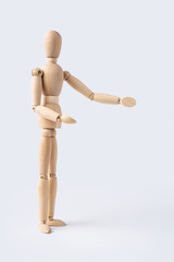 wooden mannequin with welcome gesture