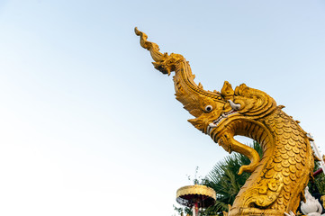 the serpent Buddhism in Chiangrai temple north of Thailand with soft-focus and over light in the background