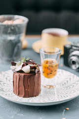 Crème brûlée with chocolate dessert with flowers. Foodstyling with tea on wooden background.