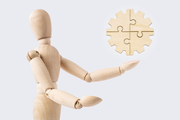 wooden mannequin with surreal jigsaw gear