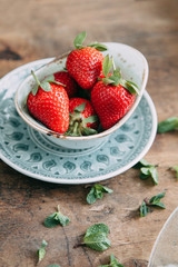 Pavlova dessert with berries in a beautiful composition. Foodstyling on a wooden background with coffee and strawberries.