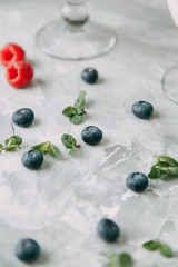 Pavlova dessert with berries in a beautiful composition. Foodstyling on a wooden background with coffee and strawberries.