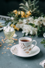 Coffee with mint on a wooden table. Food styling and desserts with flowers.