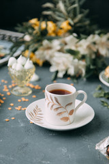 Coffee with mint on a wooden table. Food styling and desserts with flowers.