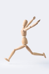 running wooden mannequin isolated on white background