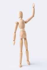 wooden mannequin with welcome gesture