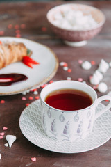 Croissants on a chic table with coffee and desserts. Food styling and layout with jam and berries.