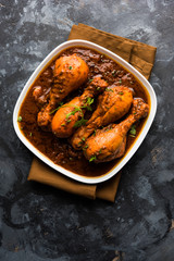 Chicken leg / drumstick curry or Murg Tangri/tangdi masala. Served in a bowl over moody background. Selective focus
