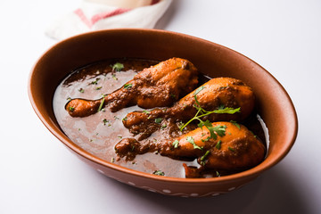 Chicken leg / drumstick curry or Murg Tangri/tangdi masala. Served in a bowl over moody background. Selective focus