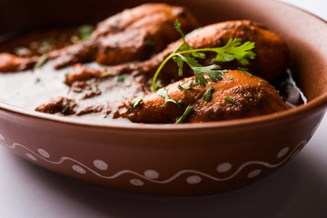 Chicken leg / drumstick curry or Murg Tangri/tangdi masala. Served in a bowl over moody background. Selective focus