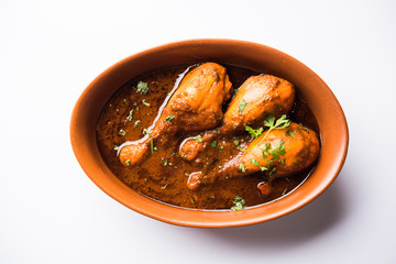 Chicken leg / drumstick curry or Murg Tangri/tangdi masala. Served in a bowl over moody background. Selective focus