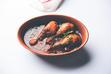 Chicken leg / drumstick curry or Murg Tangri/tangdi masala. Served in a bowl over moody background. Selective focus