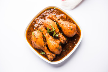 Chicken leg / drumstick curry or Murg Tangri/tangdi masala. Served in a bowl over moody background. Selective focus