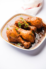 Chicken leg / drumstick curry or Murg Tangri/tangdi masala. Served in a bowl over moody background. Selective focus