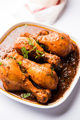 Chicken leg / drumstick curry or Murg Tangri/tangdi masala. Served in a bowl over moody background. Selective focus