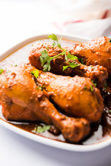 Chicken leg / drumstick curry or Murg Tangri/tangdi masala. Served in a bowl over moody background. Selective focus