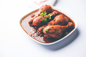 Chicken leg / drumstick curry or Murg Tangri/tangdi masala. Served in a bowl over moody background. Selective focus