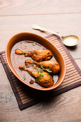 Chicken leg / drumstick curry or Murg Tangri/tangdi masala. Served in a bowl over moody background. Selective focus