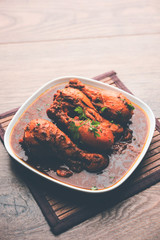 Chicken leg / drumstick curry or Murg Tangri/tangdi masala. Served in a bowl over moody background. Selective focus