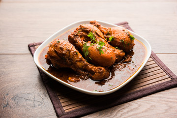 Chicken leg / drumstick curry or Murg Tangri/tangdi masala. Served in a bowl over moody background. Selective focus